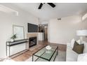 Bright living room boasts a fireplace, and comfortable seating arrangements with view into kitchen at 3830 E Lakewood E Pkwy # 2154, Phoenix, AZ 85048