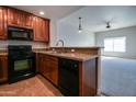 Open kitchen boasts granite countertops and dark wood cabinetry at 5450 E Deer Valley Dr # 4201, Phoenix, AZ 85054