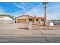 House exterior with tan stucco, two-car garage, and a mature palm tree in the front yard at 6249 S Parkside Dr, Tempe, AZ 85283
