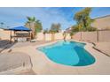 Inviting kidney-shaped pool with a surrounding patio and a shaded pergola area at 6249 S Parkside Dr, Tempe, AZ 85283