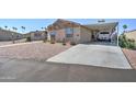Tan two-bedroom house with carport and parked truck at 6722 W Taylor St # 294, Phoenix, AZ 85043