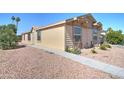 Tan two-bedroom house with walkway and desert landscaping at 6722 W Taylor St # 294, Phoenix, AZ 85043