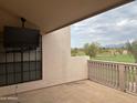 Relaxing balcony with a view of a golf course and mounted TV at 7800 E Lincoln Dr # 2047, Scottsdale, AZ 85250