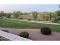 Ground level view of a manicured lawn and walkway next to a golf course at 7800 E Lincoln Dr # 2047, Scottsdale, AZ 85250