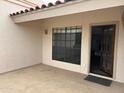 Private patio with tile flooring, stucco walls, and an open doorway at 7800 E Lincoln Dr # 2047, Scottsdale, AZ 85250