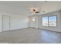 Spacious living room with gray flooring, and view to front door and window at 10073 W Mission Dr, Arizona City, AZ 85123