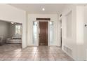 Bright and airy entryway with tile flooring and a modern door at 11065 E Mark Ln, Scottsdale, AZ 85262