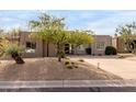 Stunning desert landscape enhances this single-level home's curb appeal at 11065 E Mark Ln, Scottsdale, AZ 85262