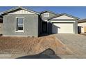 Gray house with white garage door and newly landscaped front yard at 11446 E Utah Ave, Mesa, AZ 85212