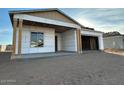 Unfinished home exterior with covered patio and exposed framing at 11457 E Utopia Ave, Mesa, AZ 85212