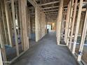 Unfinished interior with wood framing, electrical wiring and flooring at 11457 E Utopia Ave, Mesa, AZ 85212