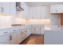 Modern kitchen with white cabinets, stainless steel appliances, and quartz countertops at 1357 E Cherrywood Pl, Chandler, AZ 85249