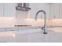 Modern kitchen sink and faucet with white quartz countertop at 1357 E Cherrywood Pl, Chandler, AZ 85249