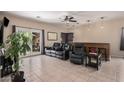 Gathering room with a wet bar, black leather recliners, and tiled floor at 14570 N 142Nd Ln, Surprise, AZ 85379