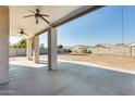 Covered patio with ceiling fans, concrete flooring, and a view of the backyard at 14614 N 153Rd Ct, Surprise, AZ 85379