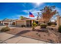 Single story home with a spacious front yard and American flag at 1511 W El Monte Pl, Chandler, AZ 85224