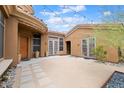 Private courtyard entry with string lights and desert landscaping at 1731 W Steinway Dr, Phoenix, AZ 85041