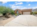 Single-story home with tan stucco exterior, attached garage, and desert landscaping at 1731 W Steinway Dr, Phoenix, AZ 85041