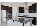 Kitchen island with granite countertop and seating space at 18104 W Silverwood Dr, Goodyear, AZ 85338