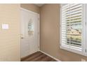 Front entry with white door, wood floors, and window at 1833 W Citrus Way, Phoenix, AZ 85015