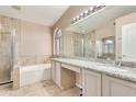 Elegant bathroom with double sinks, granite countertops, and a soaking tub at 18466 N 5Th Ave, Phoenix, AZ 85023