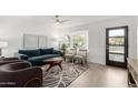 Open living area featuring a teal sofa and bay window at 1913 E Sandra Ter, Phoenix, AZ 85022