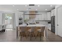 Modern kitchen with large island and breakfast bar, white cabinets, and wood accents at 205 W Blue Ridge Way, Chandler, AZ 85248