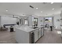 Open concept kitchen with large island, wine cooler, and views into living room at 205 W Blue Ridge Way, Chandler, AZ 85248