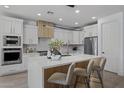 Modern kitchen features a large island, double ovens, and sleek countertops at 205 W Blue Ridge Way, Chandler, AZ 85248