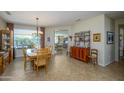 Bright dining room with a wooden table and access to the living area at 21705 N Black Bear Lodge Dr, Surprise, AZ 85387