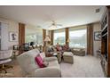 Comfortable living room featuring a sectional sofa and large windows at 21705 N Black Bear Lodge Dr, Surprise, AZ 85387