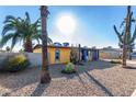 Bright yellow house with desert landscaping and a large cactus at 2235 W Villa Rita Dr, Phoenix, AZ 85023