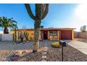 Charming single story home featuring mature desert landscaping, stone pathway, and a covered porch at 2235 W Villa Rita Dr, Phoenix, AZ 85023