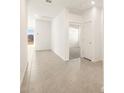 Bright hallway with tile flooring leading to a room with carpet at 3403 E Audrey Dr, San Tan Valley, AZ 85143