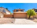 Tan two-story house with attached garage and driveway, in a residential area at 3745 W Carol Ann Way, Phoenix, AZ 85053