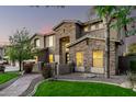 Two-story house with stone accents and a landscaped front yard with a walkway at 4142 E Ravenswood Dr, Gilbert, AZ 85298