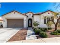 White house with brown garage door and walkway at 4415 N Sidney St, Buckeye, AZ 85396