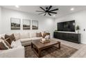 Cozy living room with sectional sofa, coffee table, and large TV at 5644 W Jackalope Ln, Laveen, AZ 85339