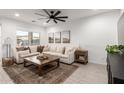 Bright and airy living room featuring a sectional sofa and large windows at 5644 W Jackalope Ln, Laveen, AZ 85339