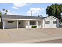 Front view of a white single story home with carport at 6732 E Culver St, Scottsdale, AZ 85257