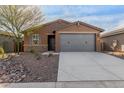 Front view of a one-story house with gray garage doors at 6843 W Samantha Way, Laveen, AZ 85339