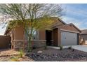 One story home with gray garage door and drought-tolerant landscaping at 6843 W Samantha Way, Laveen, AZ 85339