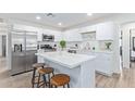 Modern kitchen featuring white cabinets, a large island, and stainless steel appliances at 899 E Flint St, Chandler, AZ 85225