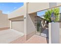 View of the garage and gated entry to a tan house at 9025 N 86Th Pl, Scottsdale, AZ 85258