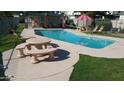 Inviting community pool with a patio table and chairs for relaxation at 9054 N 51St Ln, Glendale, AZ 85302