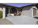 Brick home exterior with covered porch, two chairs, and holiday decor at 10178 W San Lazaro Dr, Arizona City, AZ 85123