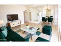 Virtually staged living room with green sofas and a marble coffee table at 102 W Maryland Ave # B2, Phoenix, AZ 85013