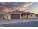 Newly built home with a two-car garage and neutral color scheme at 125 Ironwood Pl, Wickenburg, AZ 85390