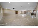 Open-concept living space with tile floors and modern kitchen at 125 Ironwood Pl, Wickenburg, AZ 85390