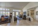 Spacious living room with high ceilings, fireplace, and dining area at 11736 E Del Timbre Dr, Scottsdale, AZ 85259